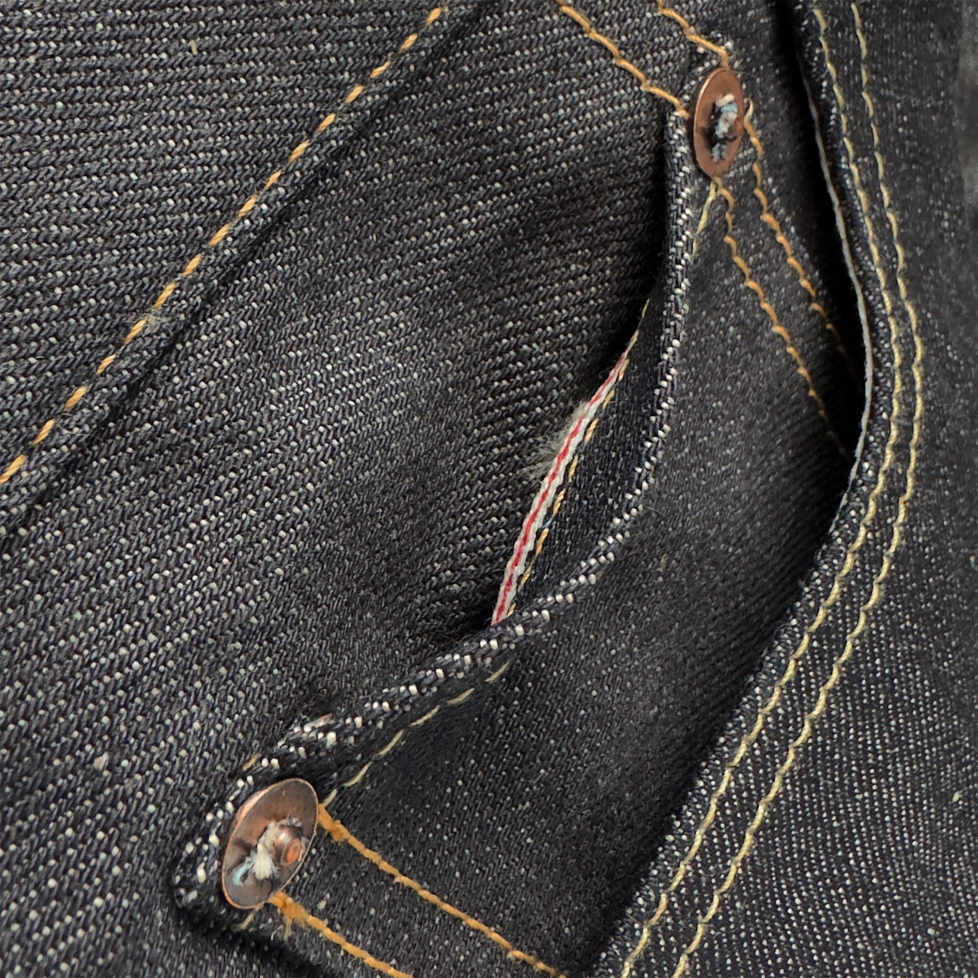 Closeup of the HFD-01 coin watch pocket on Japanese selvedge denim relaxed fit wide leg jeans showing redline selvedge edge detail.