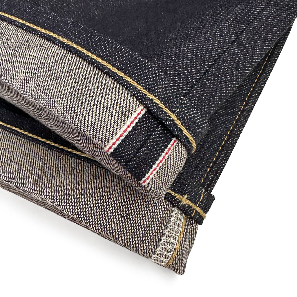 Closeup of the HFD-01 redline selvedge ID and vintage-style chain stitched hem of Japanese selvedge denim relaxed fit wide leg jeans.