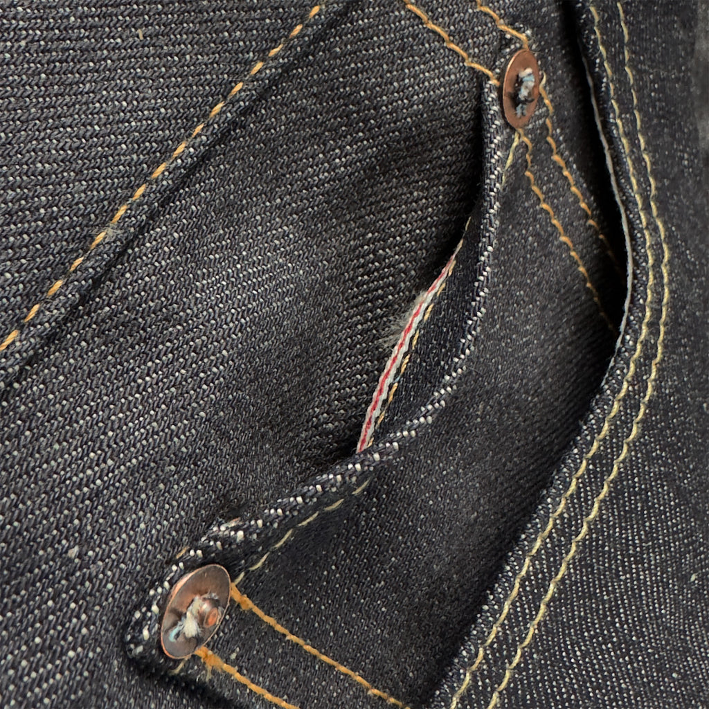 Closeup of the HFD02 coin watch pocket on Japanese selvedge denim relaxed fit tight tapered leg jeans showing redline selvedge edge detail.