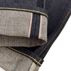 Closeup of the HFD02 redline selvedge ID and vintage-style chain stitched hem of Japanese selvedge denim relaxed fit tight tapered leg jeans.