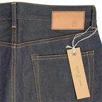 Closeup of the HFD03 jacron paper patch and kraft paper hangtag with logo on Japanese selvedge denim regular fit slim leg jeans.