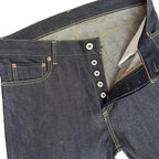 Closeup of HFD04 Japanese selvedge denim slim fit straight leg jeans showing the button fly, waistband, rivets, and front pockets.