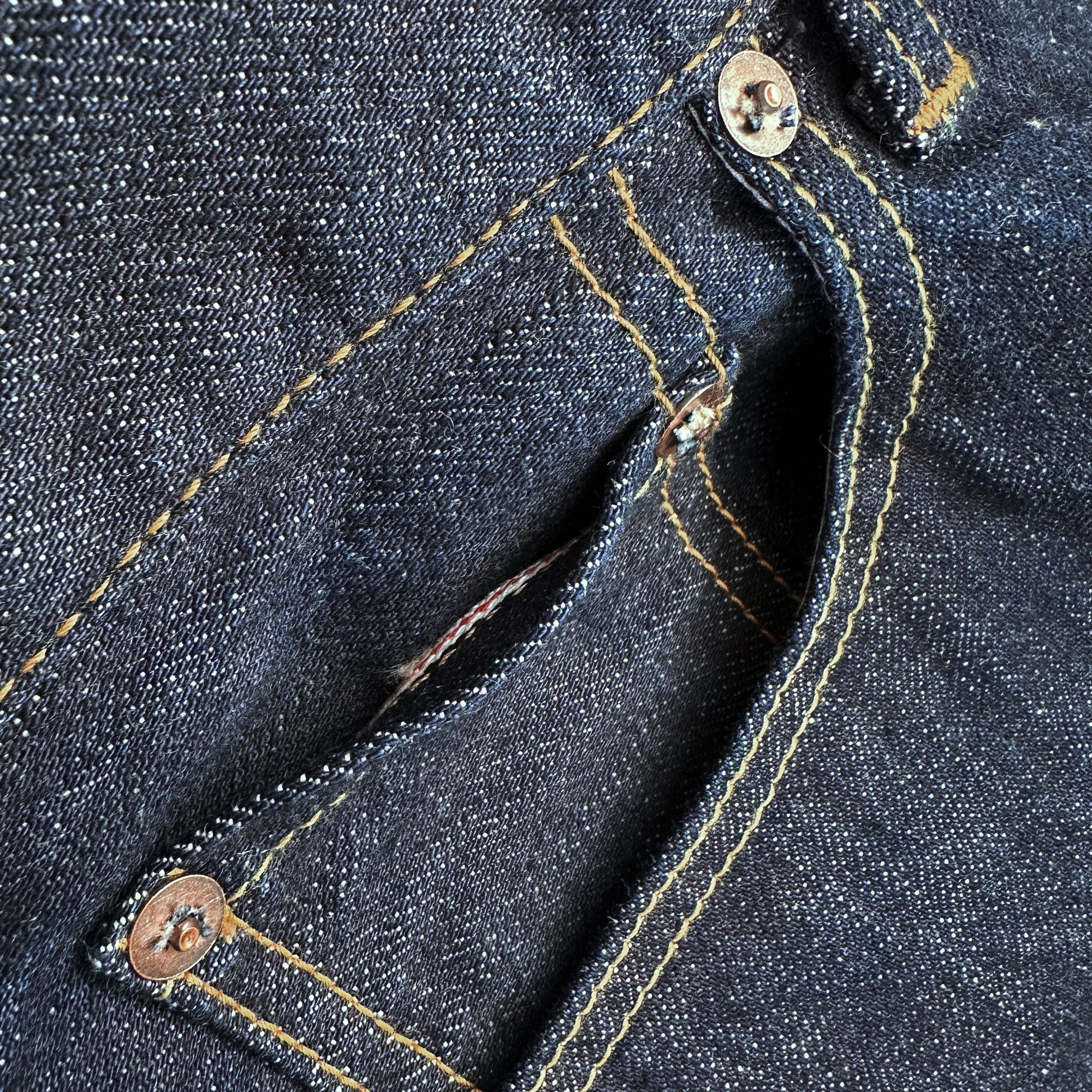 Closeup of the HFD-02 coin watch pocket on Japanese selvedge denim  once washed relaxed fit tight tapered leg jeans showing redline selvedge edge detail.