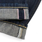 Closeup of the HFD-02 redline selvedge ID on the hem of Japanese selvedge denim  once washed relaxed fit tight tapered leg jeans.