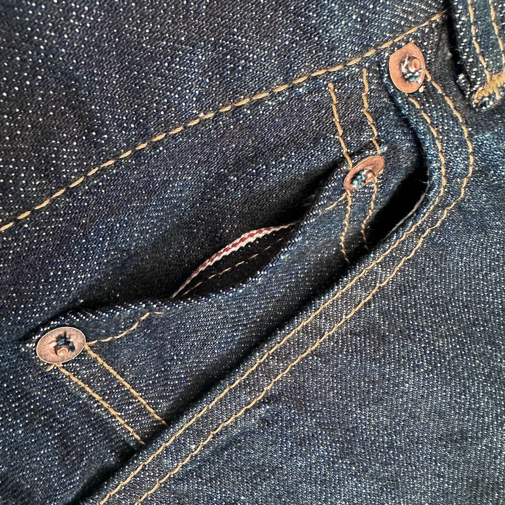 Closeup of the HFD-04W coin watch pocket on Japanese selvedge denim once washed slim fit straight leg jeans showing redline selvedge edge detail.