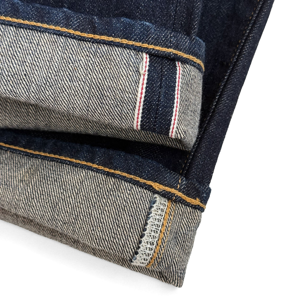 Closeup of the HFD-04W redline selvedge ID on the hem of Japanese selvedge denim once washed slim fit straight leg jeans.
