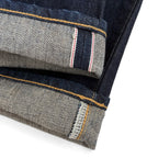Closeup of the HFD-04W redline selvedge ID on the hem of Japanese selvedge denim once washed slim fit straight leg jeans.