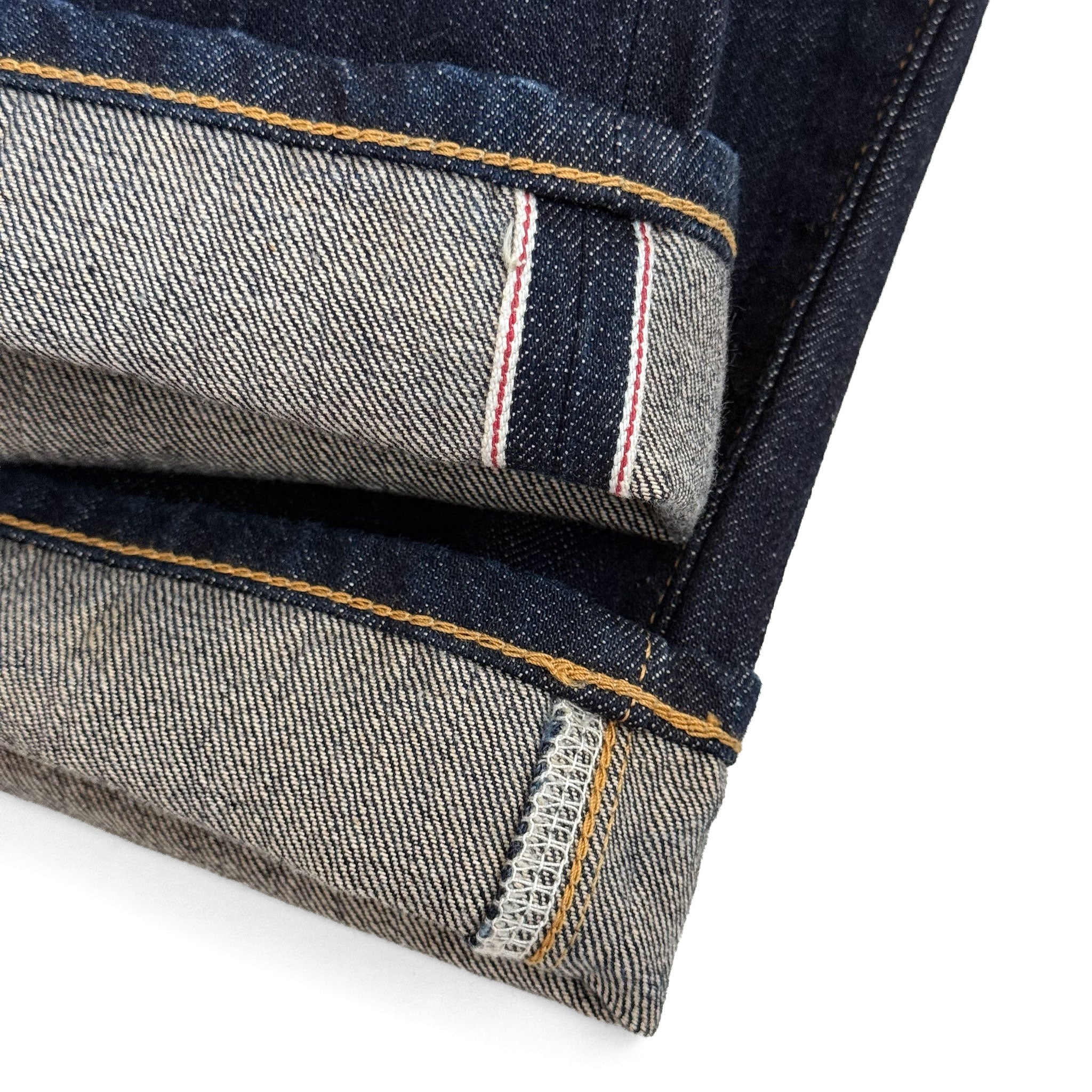 Closeup of the HFD-04W redline selvedge ID on the hem of Japanese selvedge denim once washed slim fit straight leg jeans.